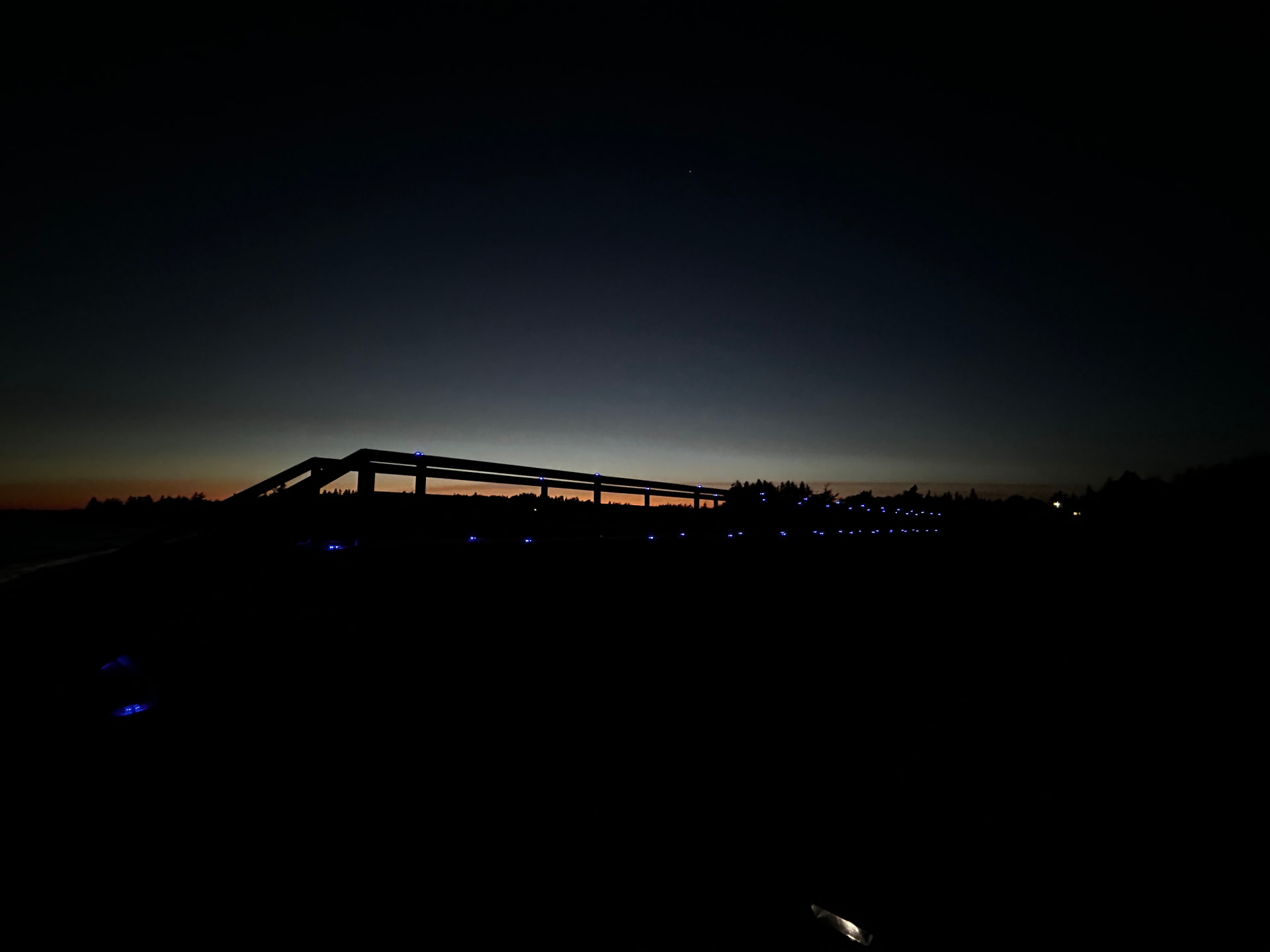 Silhouette of the boardwalk against the last orange light of sunset